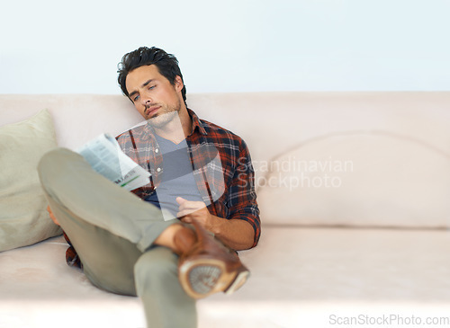 Image of Man, reading and relax with newspaper on couch in home, living room and learning about event or story in media, News, mockup and person with article in the paper on sofa in apartment with information