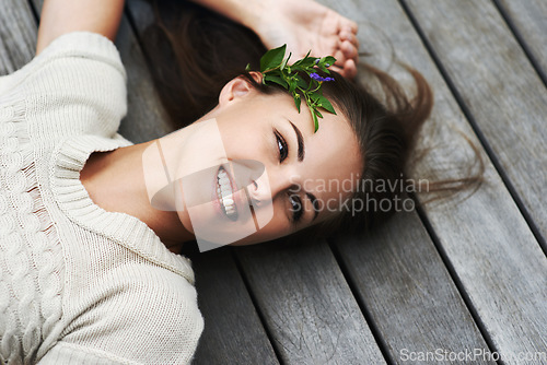 Image of Woman lying on her porch, funny and summer with smile, happiness and chilling on a weekend break. Person, outdoor or girl with holiday, cheerful and flowers in her hair, relax or floral with vacation