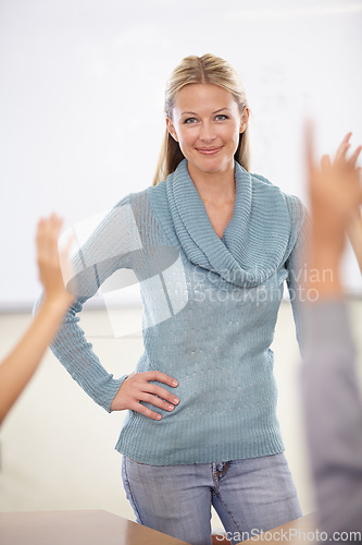 Image of Hands in the air, portrait and teacher with students, education and knowledge in a classroom. Woman, educator and kids with questions, answers and child development with a smile, learning and school