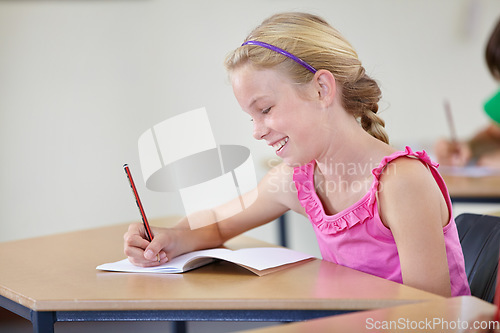 Image of School, girl and smile for writing in classroom, studying lesson or learning assessment at desk. Child, student or happy kid drawing in notebook of academic development, educational test or knowledge