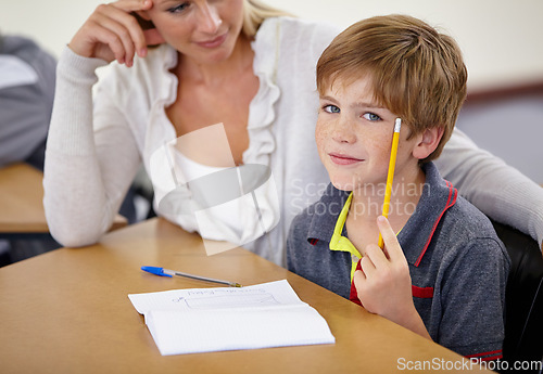 Image of Teacher woman, classroom and boy at desk in portrait with support, advice and knowledge for education. People, learning and development for person, child and pencil for progress, school or academy