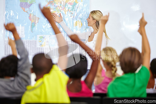 Image of Back of students, teacher and raise hands for questions, education or learning with geography quiz in classroom. Youth, group of kids and school for teaching support, map ideas and answer or test