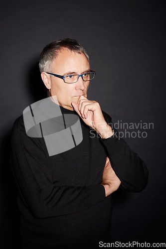 Image of Senior man, thinking and ideas with decision, choice and confident guy on a dark studio background. Mature person, mockup space and model with glasses, wonder and thoughts with planning or retirement