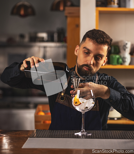 Image of Professional barman using jigger