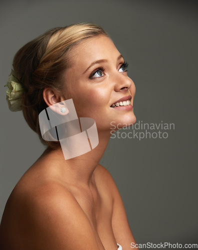 Image of Thinking, smile and woman with cosmetics, beauty and wellness on a grey studio background. Person, girl and model with shine, skincare or grooming with texture, healthy skin and dermatology with glow