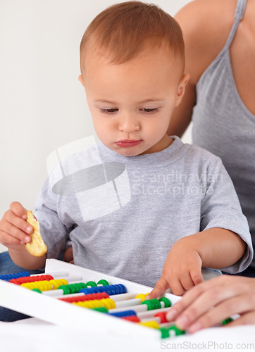 Image of Abacus, toy and baby with mother playing, learning and education for child development on bed. Bonding, math and closeup of mom teaching kid, infant or toddler with counting and snack at home.