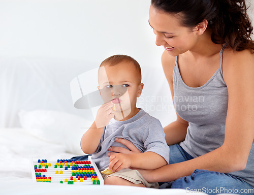 Image of Abacus, relax and baby with mother playing, learning and teaching for child development on bed. Bonding, toy and closeup of mom teaching kid, infant or toddler with counting in bedroom at home.