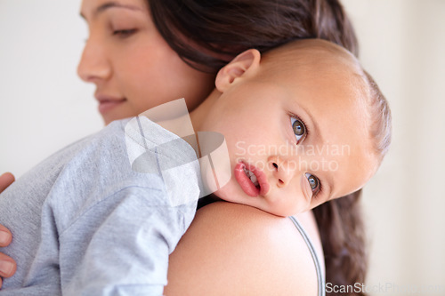 Image of Mom holding baby boy in home for sleep, bonding and child care with support in morning. Woman, tired toddler and nap time together in bedroom with development, trust and safety with mothers love.