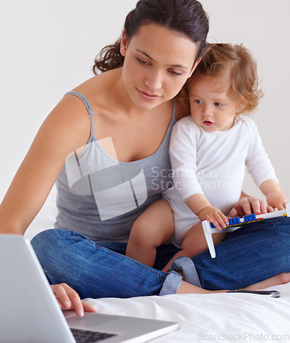 Image of Laptop, baby and mother in bed for remote work, learning or online education in home. Freelancer parent, computer and kid in bedroom playing with abacus, child care and toddler together with family