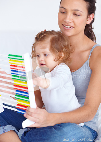 Image of Abacus, math and girl baby with mom playing, learning and teaching for child development on bed. Bonding, toy and young mother teaching kid, infant or toddler with counting in bedroom at home.