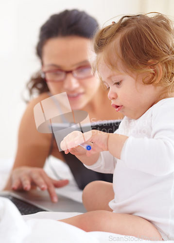 Image of Mom, working and multitasking on laptop with baby in home for remote work or writing project. Infant, kid and mother busy with freelance productivity on computer and child in bedroom playing with pen