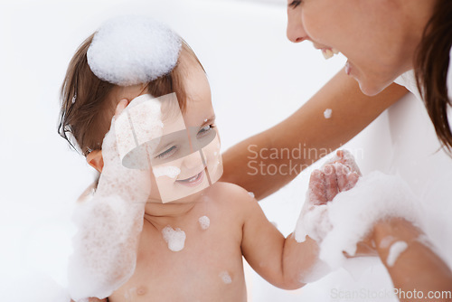 Image of Baby, bath and mother laughing in a bathroom with cleaning, foam and help with love and support. Care, mom and young child with soap in a home with bonding and washing for wellness and hygiene