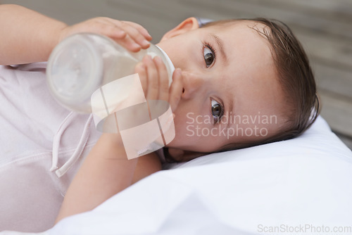 Image of Baby, kid and drinking bottle for nutrition, liquid food and relaxing together on porch at home. Girl, toddler and formula for health or child development in outdoors, feeding and milk for wellness