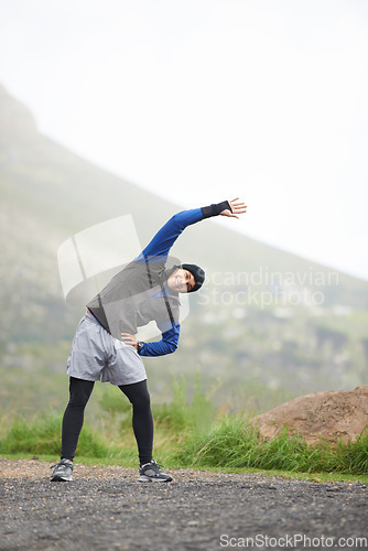 Image of Man, stretching and prepare for fitness outdoor, mountain and nature with runner and start exercise. Workout, training and warm up in road, ready for race or cardio with endurance for health