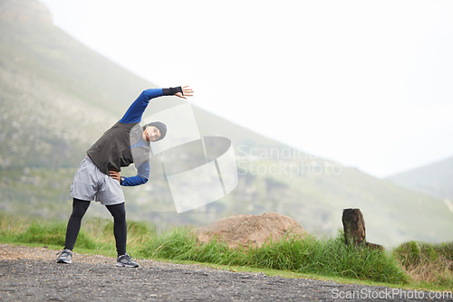 Image of Man, stretching and start fitness outdoor, mountain and nature with runner and exercise. Workout, training and warm up in road, ready for race or cardio with endurance for health, running and sports