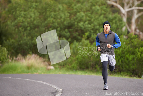 Image of Fitness, energy and a man in the street for running, training and marathon competition. Health, exercise and a male runner or athlete in the road for sports, morning cardio or a workout in nature