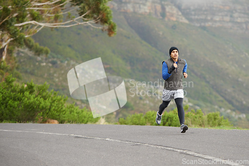 Image of Fitness, exercise and a man in the street for running, training and marathon competition. Health, energy and a male runner or athlete in the road for sports, morning cardio or a workout in nature