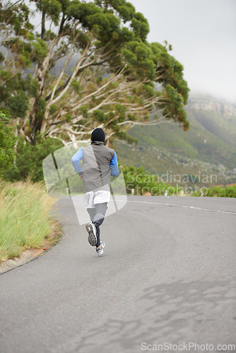 Image of Back, fitness and man running in the road for morning cardio, training or marathon. Health, sports and a person, athlete or male runner in street for a triathlon, active or exercise for competition