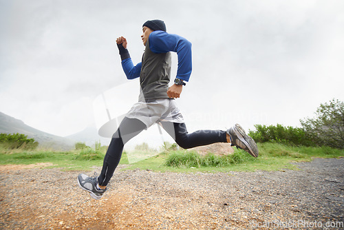 Image of Fitness, runner and man running in nature training, cardio exercise and endurance workout for wellness. Sports, challenge or healthy male athlete on fast jog on path outdoors with speed or action