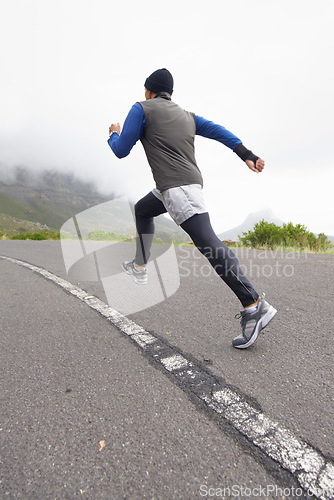 Image of Back, fitness and man running on road in training, cardio exercise or endurance workout for wellness. Sports, runner or healthy athlete on fast jog on path outdoors with speed, challenge or action