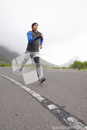 Image of Sports, fitness and man running on road in training, cardio exercise or endurance workout for wellness. Energy, runner or healthy male athlete on fast jog outdoors with speed, challenge or action