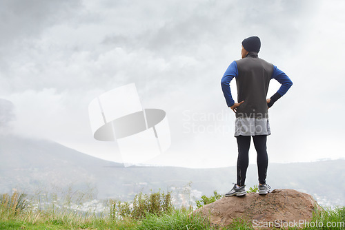 Image of Runner thinking, fitness and man in nature for training , wellness or outdoor adventure for health. Athlete, back or sports person on mountain peak with idea or inspiration for exercise or workout