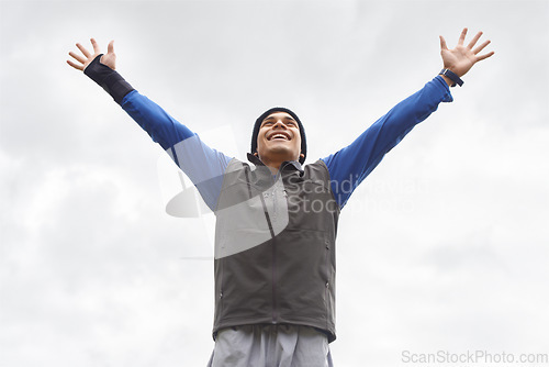Image of Happy man, runner or hands up for celebration in training adventure, exercise or workout success. Excited, sky or healthy hiker with smile, gratitude or freedom for fitness to explore nature outdoors