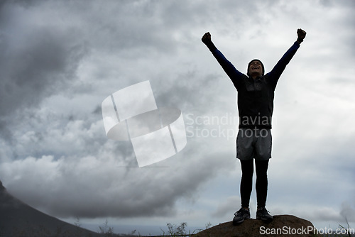 Image of Happy man, mountain peak space or hands up for celebration in training, exercise or workout success. Excited athlete, sky mockup or hiker with energy, gratitude or freedom in nature for fitness