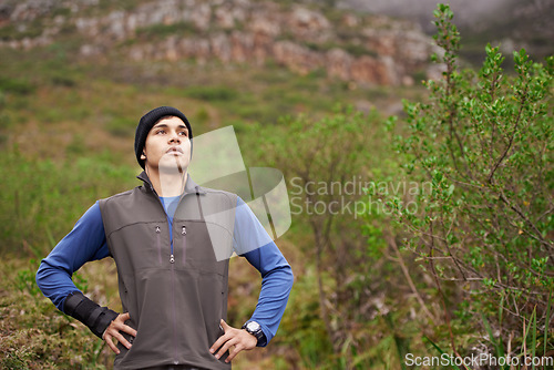 Image of Man, hiking and thinking for adventure, mountain and face for trail, exercise and workout. Hiker, fitness and climber for training, forest and nature to explore, hobby and heart health in outdoors