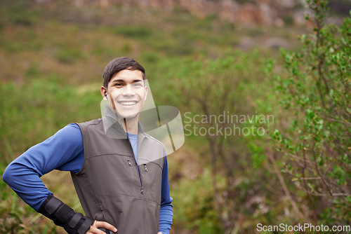 Image of Earphones, runner or portrait of a happy man in forest for workout, exercise or fitness training in woods. Nature, confident sports person or healthy athlete with radio music audio, wellness or smile