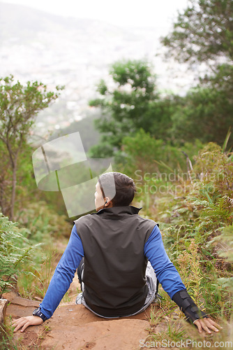 Image of Back, rock and man on break in nature training, cardio exercise and endurance workout for wellness. Sports person, fitness fatigue or tired athlete resting in forest or mountain trail outdoors