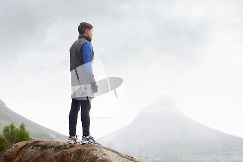 Image of Man, mountain peak space or thinking for adventure, mockup or trail in exercise or workout. Hiker, sky or climber training in nature to explore hiking for wellness, fitness or heart health outdoors