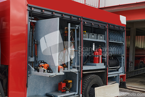 Image of Close-up of essential firefighting equipment on a modern firetruck, showcasing tools and gear ready for emergency response to hazardous fire situations