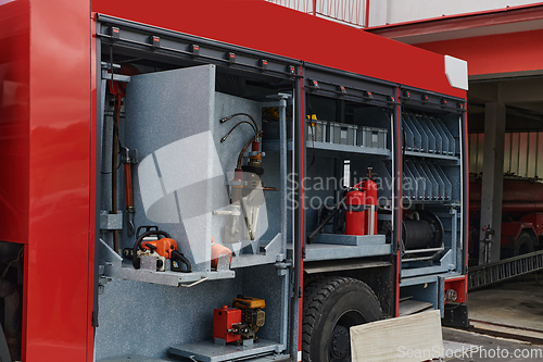 Image of Close-up of essential firefighting equipment on a modern firetruck, showcasing tools and gear ready for emergency response to hazardous fire situations