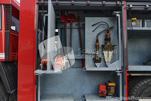 Image of Close-up of essential firefighting equipment on a modern firetruck, showcasing tools and gear ready for emergency response to hazardous fire situations