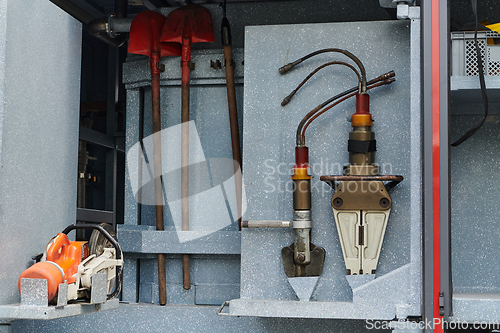 Image of Close-up of essential firefighting equipment on a modern firetruck, showcasing tools and gear ready for emergency response to hazardous fire situations