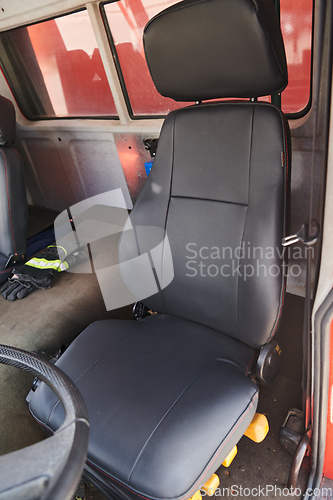 Image of The close-up capture reveals the intricate details of the ergonomic seats and high-tech interior of a modern firefighting truck, showcasing a perfect blend of functionality and safety features