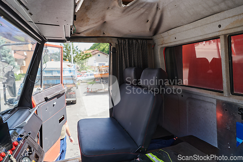 Image of The close-up capture reveals the intricate details of the ergonomic seats and high-tech interior of a modern firefighting truck, showcasing a perfect blend of functionality and safety features