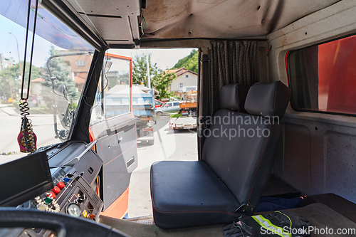 Image of The close-up capture reveals the intricate details of the ergonomic seats and high-tech interior of a modern firefighting truck, showcasing a perfect blend of functionality and safety features