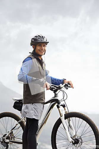 Image of Smile, portrait and a man with a bike in nature for cycling, fitness and training in nature. Happy, health and a male biker or person with a bicycle for transportation, sport or an outdoor triathlon