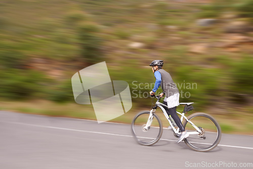 Image of Man, mountain bike and cycling on road for nature adventure, speed or outdoor extreme sports. Male person or cyclist on bicycle for fast cardio, street or uphill in exercise, practice or training