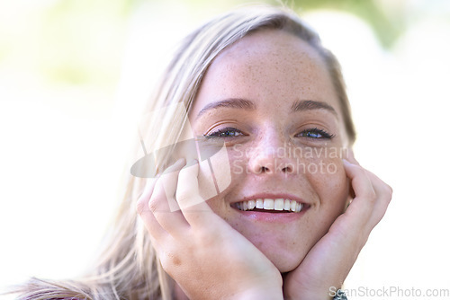 Image of Portrait, happy and beauty of woman outdoor, touch skin and facial expression in summer. Smile, face and hands of blonde female person, natural and confidence of young girl in nature in Switzerland