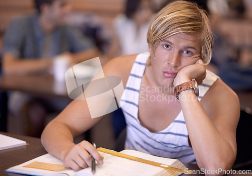 Image of University, bored and portrait of man in classroom with books for studying, learning and research. Education, college and face of student tired, sad and upset with textbooks for assignment or test