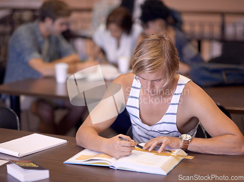 Image of University, studying and man in library with books for writing notes, learning and research with knowledge. Education, college and student with textbooks for assignment, project and test on campus