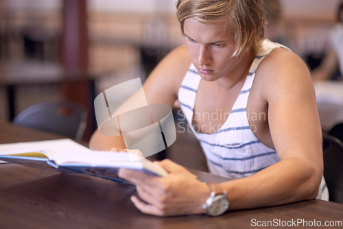 Image of University, studying and man with books for education, learning and research with knowledge in library. Reading, college and male student with textbooks for assignment, project and test on campus