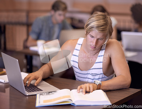 Image of University, laptop and man with books in library for studying, learning and research for knowledge. Education, college and student on computer and textbook for assignment, project and test in campus