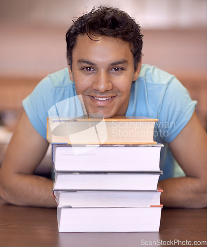 Image of Student man, portrait and stack of books for education, development and happy at college library. Person, learning and knowledge with smile, pride and research for assessment at university campus