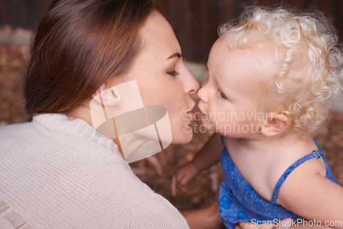 Image of Mother, love and kiss of baby in house, trust and parent support for mama bond with happiness in care. Woman, nurture and toddler daughter with together, wellness and hug kid for bonding in apartment