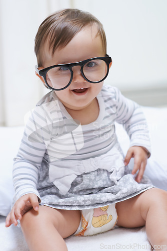 Image of Eye care, portrait or baby with vision glasses for eyesight, prescription lens frame or ocular support. Accessory, pediatric ophthalmology and infant toddler relax, silly and playing with eyeglasses