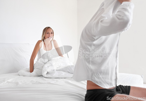 Image of Man, undress and woman in bed for relax morning as couple for romance, connection or marriage. Male person, partner and shirt in apartment or rest together in home for happiness wife, laugh or casual